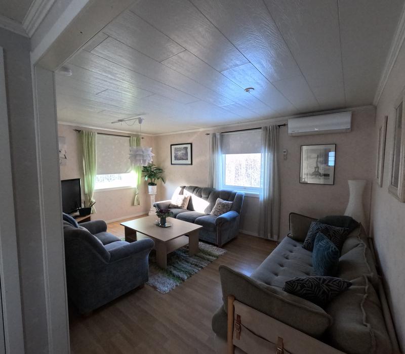 Cozy living room at Stations Hotellet with comfortable sofas and TV